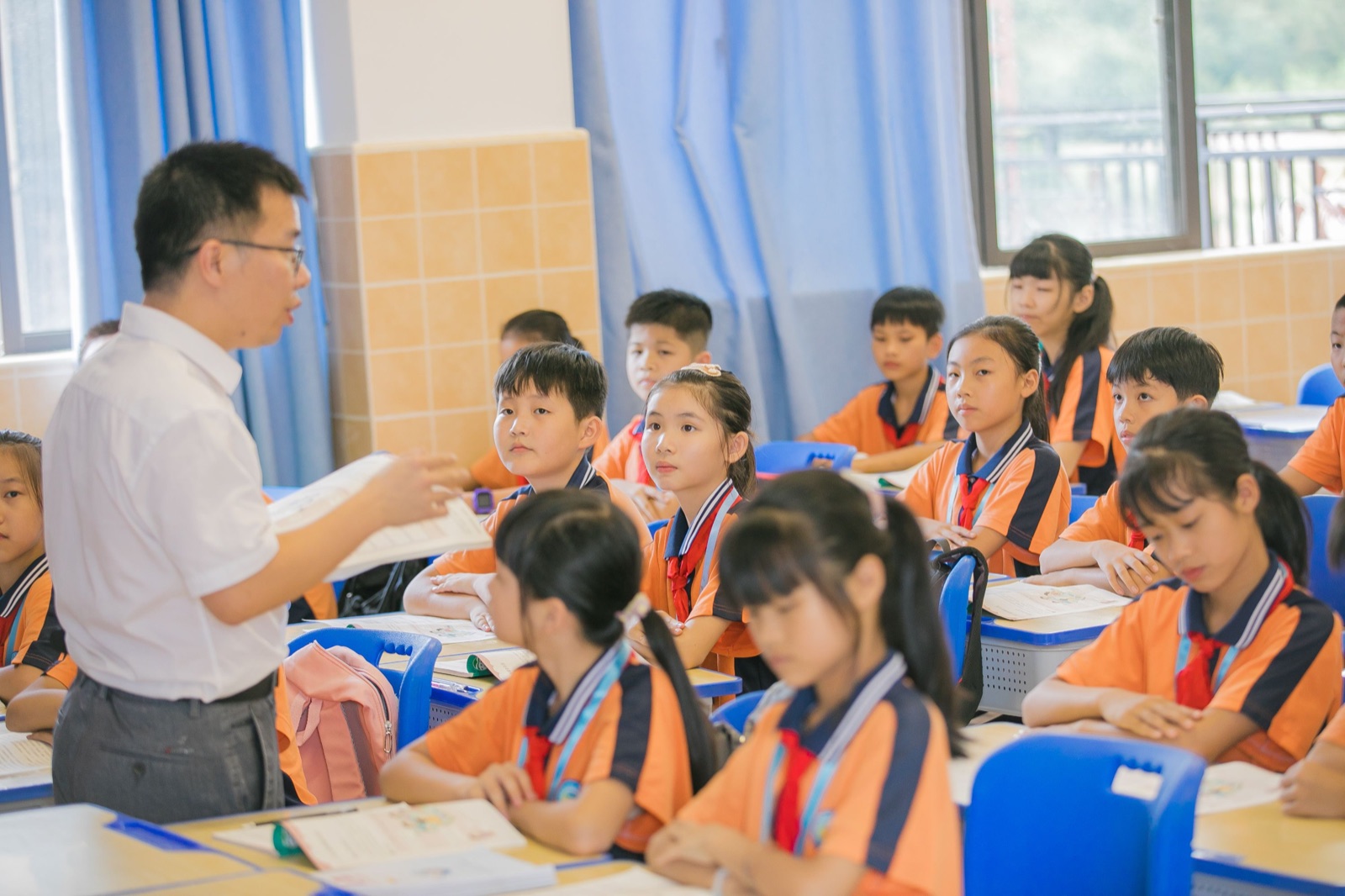 A teacher guides children during a classroom lesson.